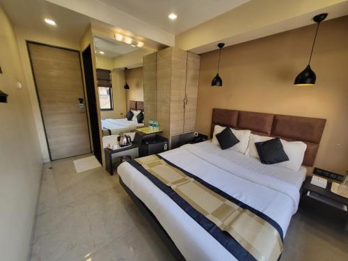 a bedroom with a large bed and a bathroom at The Fountain Inn - Fort in Mumbai