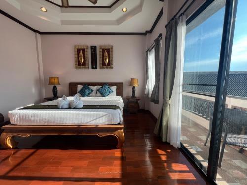 a bedroom with a bed with a view of the ocean at Pha Thai House in Chiang Mai