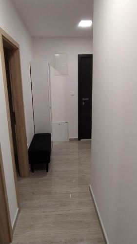 an empty room with a black chair and a door at Primošten Pool Fantasy apartmant in Primošten