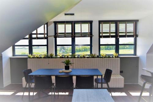 a dining room with a blue table and chairs at 17 The Fairways in Broadstairs