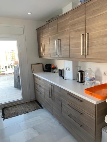 a kitchen with wooden cabinets and a counter top at Villa Calahonda - Mijas in Mijas