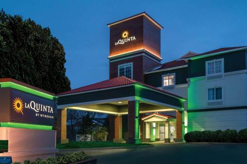 a large building with a sign on top of it at La Quinta by Wyndham Latham Albany Airport in Latham