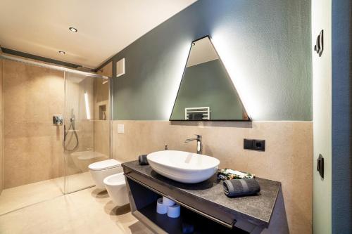 a bathroom with a sink and a shower at Aktiv Lodge Meran - Terrace Large in Saltusio