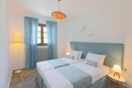 two beds in a room with blue and white at Coconut & Vanilla & Pineapple Pool Apartments #FeelsLikeHome in Kriopigi