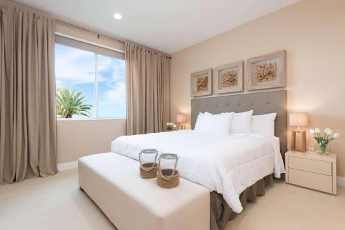 a bedroom with a large bed and a large window at Magic Village Yards Trademark Collection by Wyndham in Orlando