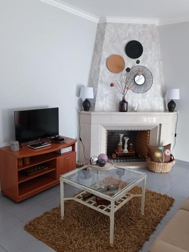 a living room with a coffee table and a fireplace at GREEN GARDEN APARTMENT IN ODIVELAS in Odivelas