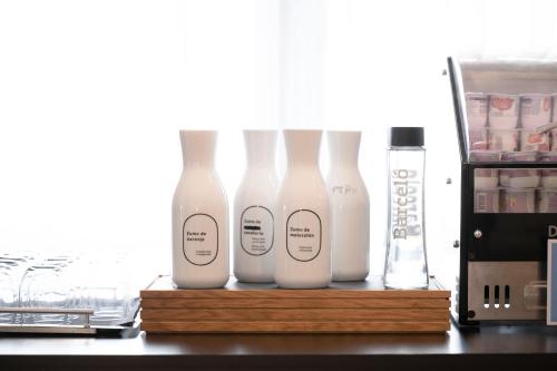 a group of four white bottles sitting on a table at Barceló León Conde Luna in León