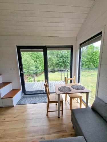 a room with a table and chairs in a house at Zielona Górka in Biskupiec