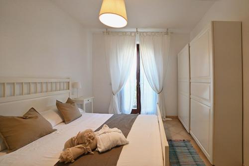 a bedroom with a large white bed with a large window at Conero Casa - Marcelli di Numana in Piazzale Tremiti 7 in Marcelli