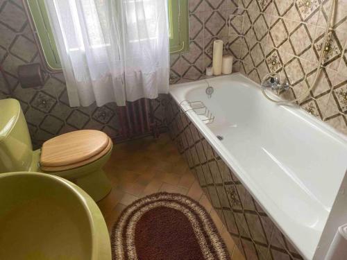 a bathroom with a tub and a toilet and a sink at Nice flat terrace big garden 10min beach'n'center in Argelès-sur-Mer
