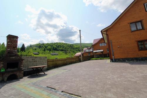 a picnic table sitting next to a brick building at Manor "U Bervinovy" in Yaremche