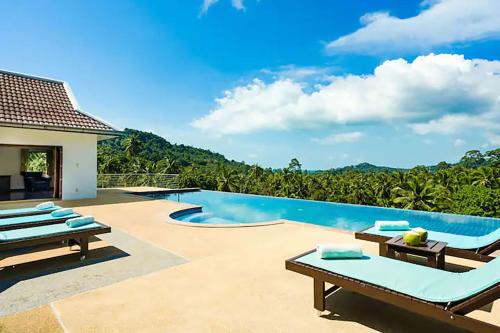 a swimming pool with a view of a villa at Villa E in Taling Ngam Beach