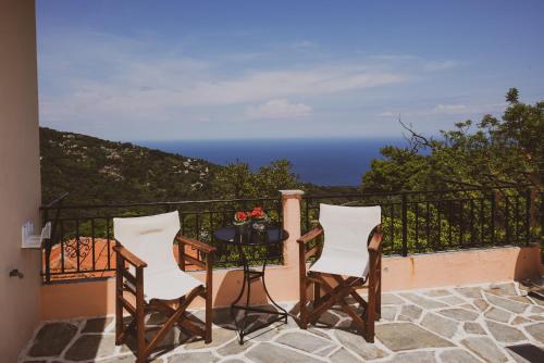 a balcony with a table and two chairs and the ocean at Pantheon 2 in Mouresi