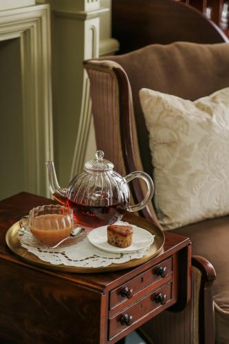 a tea set on a wooden table with a tea pot at Henrys Townhouse Marylebone, London in London