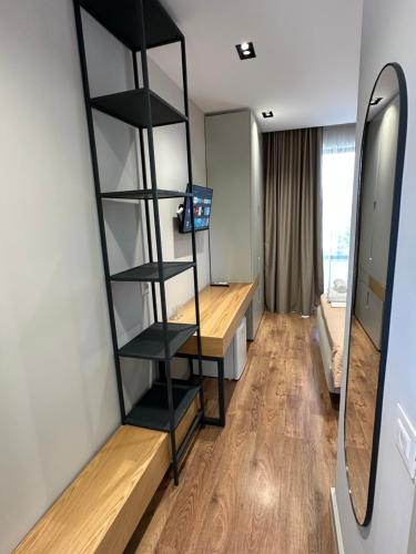 a room with a black book shelf and a desk at Hotel Ajden by Mira Mare in Ksamil