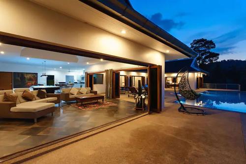 a living room of a house with a pool at Villa E in Taling Ngam Beach