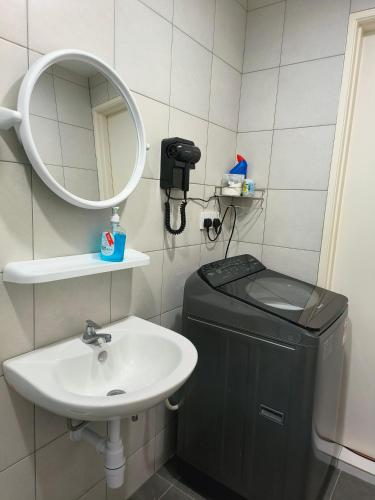 a bathroom with a toilet and a sink and a mirror at New The Sun Homestay at Sg Nibong nearby Queensbay or PISA or FTZ Bayan Lepas HENG in Bayan Lepas