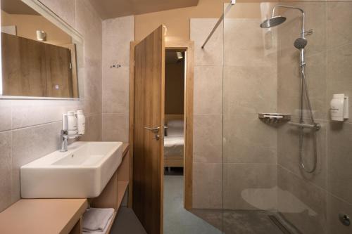 a bathroom with a sink and a shower at Holiday Homes Kačjak in Dramalj
