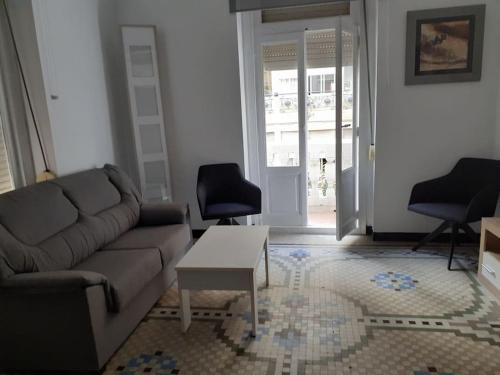 uma sala de estar com um sofá e uma mesa em Apartamento En Valencia Centro em Valência