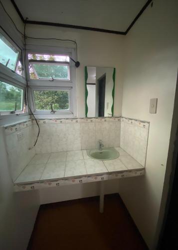 a bathroom with a sink and a mirror at Rachel's Bed and Breakfast Near Tagaytay in Silang