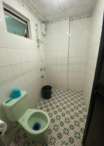 a bathroom with a toilet and a shower at Rachel's Bed and Breakfast Near Tagaytay in Silang