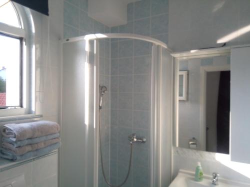 a bathroom with a shower and a sink at Ana Rooms in Krk