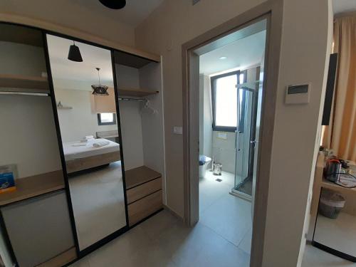 a bathroom with a mirror and a sink and a toilet at MARIVAL Luxury Living - Adults Only in Sivota