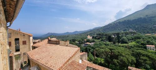 a view of a village with mountains in the background at The Charming House by 1722 in Ville-di-Paraso