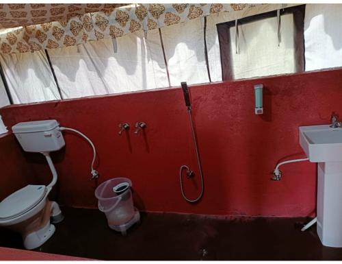 a bathroom with a shower and a toilet and a sink at Sumeru Camp,Barkot in Barkot