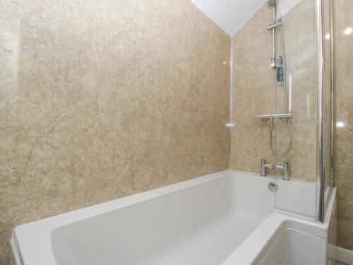 a bathroom with a shower and a bath tub at 4 Wallflower Row in Hereford