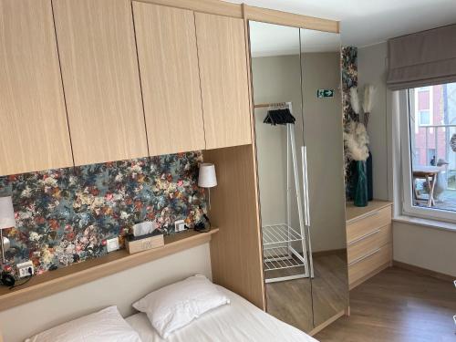 a bedroom with a bed and a glass wall at ERNA in Blankenberge