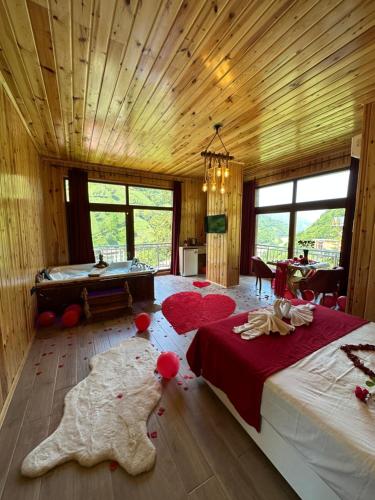 1 dormitorio con 1 cama y bañera en una habitación en Vadidekal Suite Hotel, en Çamlıhemşin