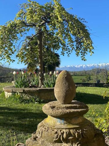 a stone statue sitting on top of a field at Rustico im Piemont mit Panorama in Clavesana