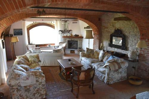 a living room with two couches and a fireplace at Rustico im Piemont mit Panorama in Clavesana
