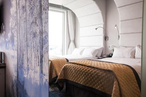 two beds in a room with a window at Wyndham Garden Brooklyn Sunset Park in Brooklyn