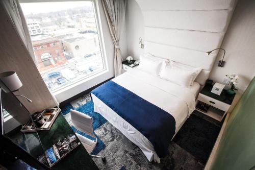 a bedroom with a bed and a large window at Wyndham Garden Brooklyn Sunset Park in Brooklyn