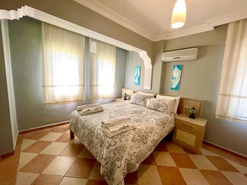 a bedroom with a bed with two towels on it at Mountain Valley Oludeniz in Oludeniz