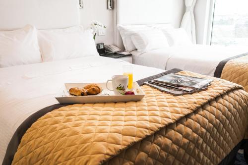 a tray of food on a bed in a hotel room at Wyndham Garden Brooklyn Sunset Park in Brooklyn