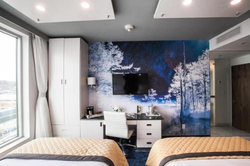 a bedroom with two beds and a desk at Wyndham Garden Brooklyn Sunset Park in Brooklyn