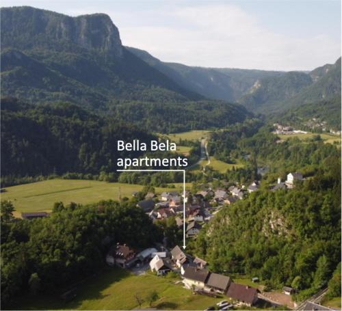 a town in the mountains with the words belkaediaedia apartments at Bella Bela Apartments 23 in Bled