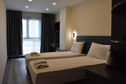 a hotel room with two beds and a window at Shishly Palace Hotel in Istanbul