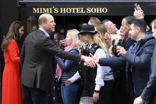un grupo de personas estrechando la mano delante de una multitud en Mimi's Hotel Soho, en Londres