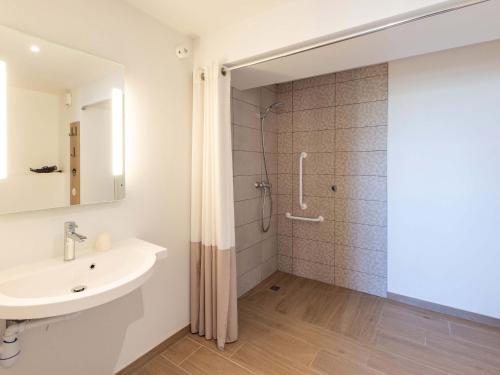 a bathroom with a shower and a sink at B&B HOTEL Rennes Parc Expo Aéroport in Bruz