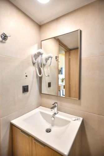 a bathroom with a sink and a mirror at Despo Hotel in Gouves