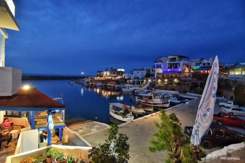 a marina at night with boats in the water at Sisi seaview apartments in Sissi