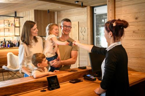a group of people standing around a table at Aldrov Resort in Vítkovice