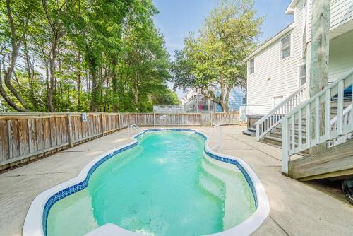 a swimming pool in the backyard of a house at Currituck Carl's in Sanderling