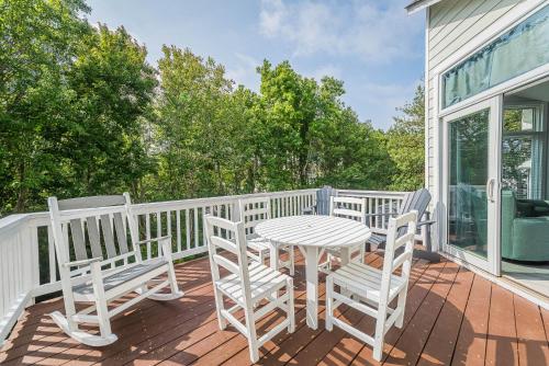 a patio with a table and chairs on a deck at Currituck Carl's in Sanderling