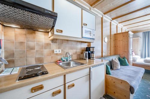 a kitchen with a sink and a counter top at Landhaus Edelweiss in Sankt Leonhard im Pitztal