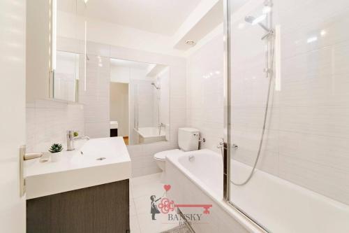 a white bathroom with a shower and a sink at Lugano Center - Apartment for 6 PEOPLE with TERRACE in Lugano